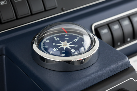 Flush mount marine compass on a boat helm.